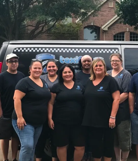 Taxi Mom team members beside a company van